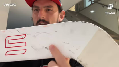 Connor Hellebuyck shows off stick from gold medal game save