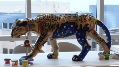 Joe DiMaggio Children’s Hospital patients decorate statue brought by Panthers with pediatric cancer ribbon colors