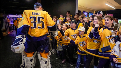 Pekka Rinne taps hands with fans