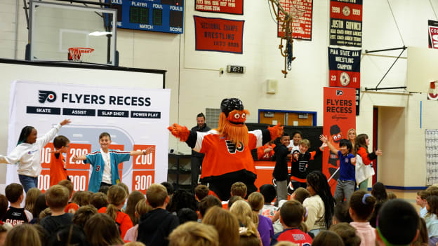 Students participate in a dance competition with Gritty