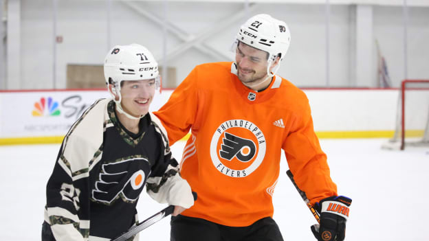 Scott Laughton skates with service member from the USO