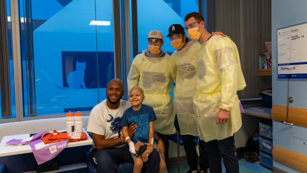 Sean Couturier, Joel Farabee, and Morgan Frost pose for a picture with a patient at the Children’s Hospital of Philadelphia.