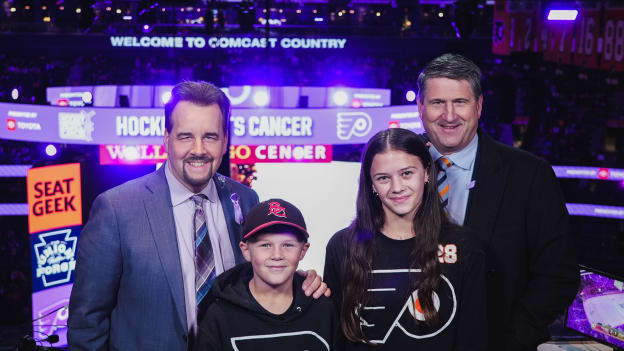 Flyers Press Pass family meets with Jim Jackson and Keith Jones in the broadcasting booth