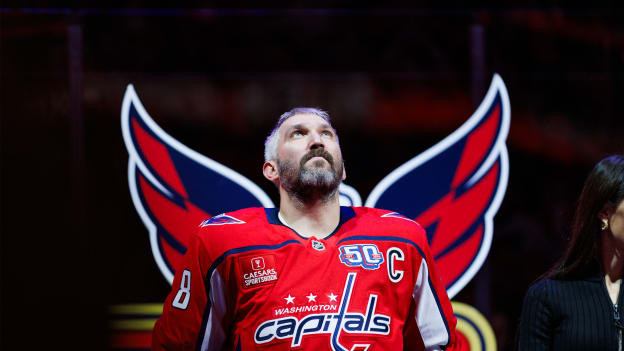 Alex Ovechkin looks on as he is celebrated for becoming the NHL's all-time goals leader with 895 goals before playing against the Carolina Hurricanes at Capital One Arena on April 10, 2025 in Washington, DC.