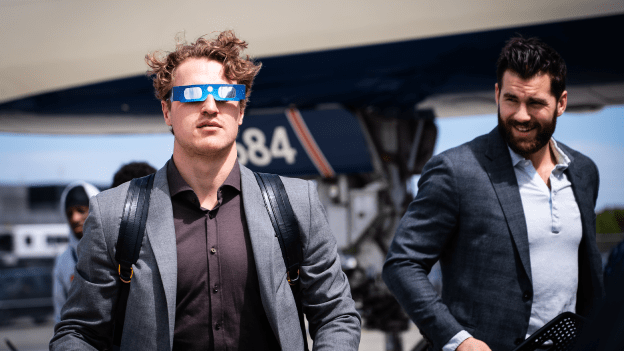 Nicolas Aube-Kubel wears solar eclipse glasses ahead of the flight to Detroit on April 8, 2024.