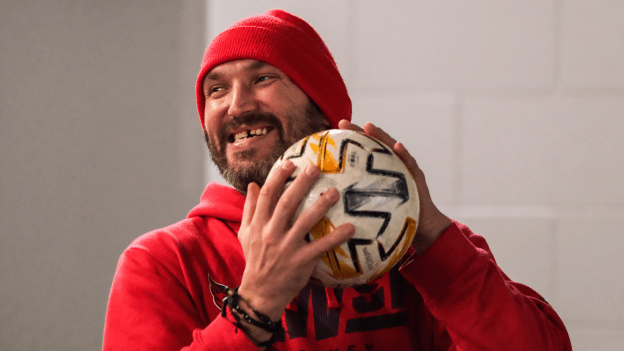 Alex Ovechkin smiles while holding a soccer ball pregame at Prudential Center on November 10, 2023.