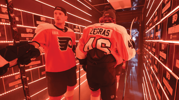 Players gathered in the tunnel lined with service member tributes