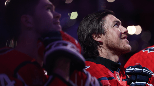 T.J. Oshie and teammates stand on the ice with guests for a Hockey Fights Cancer presentation before the Capitals against the Columbus Blue Jackets at Capital One Arena on November 18, 2023