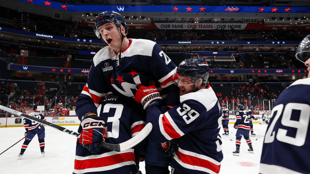 Tom Wilson and Anthony Mantha pick up Aliaksei Protas during warmups just prior to a game against the Los Angeles Kings at Capital One Arena on January 7, 2024