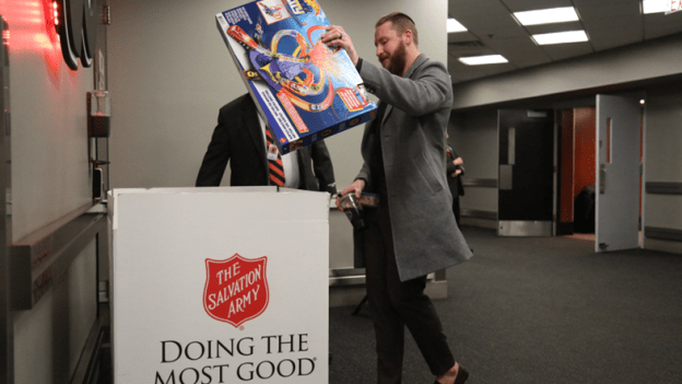 Nicolas Deslauriers donates a toy to the Salvation Army Holiday Toy Drive