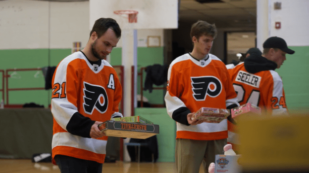 Scott Laughton and Egor Zamula sorting toy donations collected from the team’s Toy Drive with Salvation Army