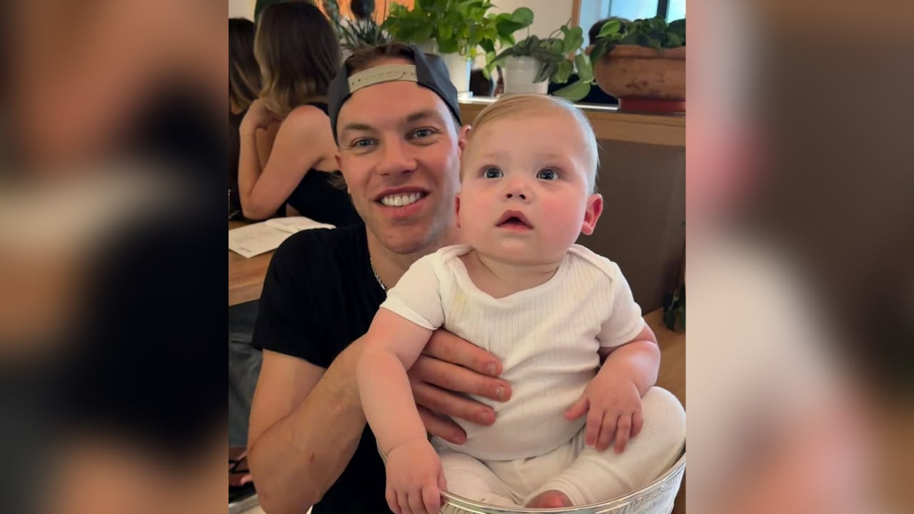 Hall poses with young son in Stanley Cup to celebrate title