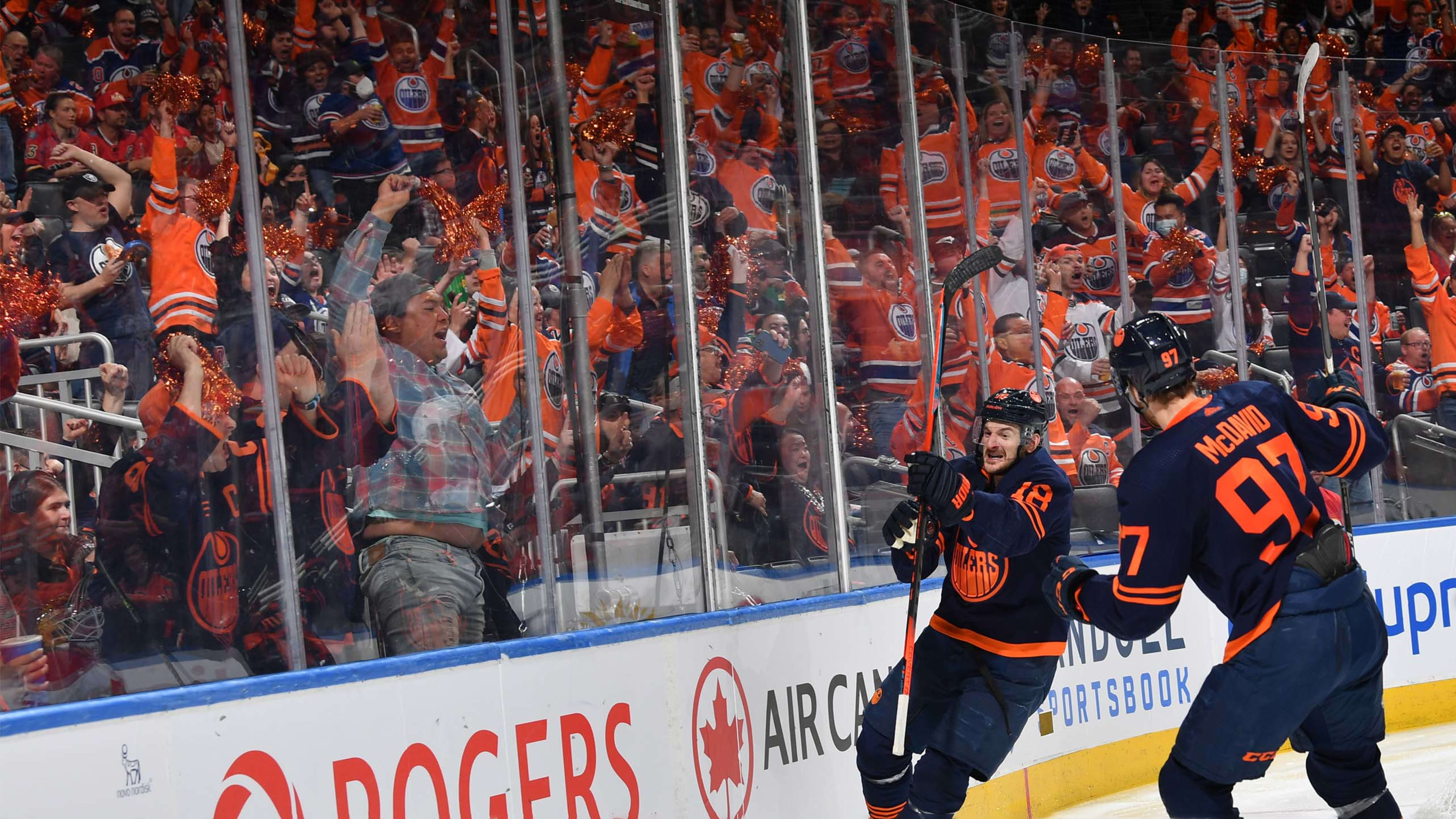 Oilers fans next to the glass as Hyman celebrates goal