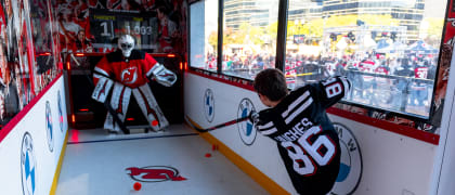 Kid shooting a hockey puck, playing the Devils BMW Experience Mobile Tour Shooting Challenge game