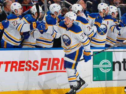 Peyton Krebs of the Buffalo Sabres checks Luke Hughes of the New News  Photo - Getty Images