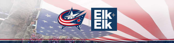 Photo of people in camo military uniforms stretching the American flag over the ice at Nationwide Arena. The Blue Jackets logo and Elk and Elk logos are side by side overlaid on top of the photo.