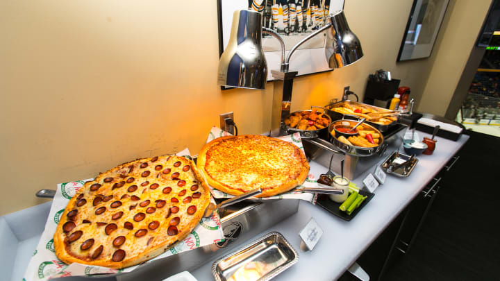 Photo from inside one of key bank center's suites showing a spread featuring pizza and wings