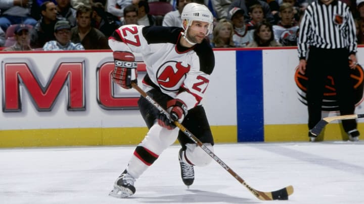 Scott Niedermayer #27 of the New Jersey Devils controls the puck during the game against the Carolina Hurricanes at the Continental Airlines Arena in East Rutherford, New Jersey. The Devils defeated the Hurricanes 3-6.