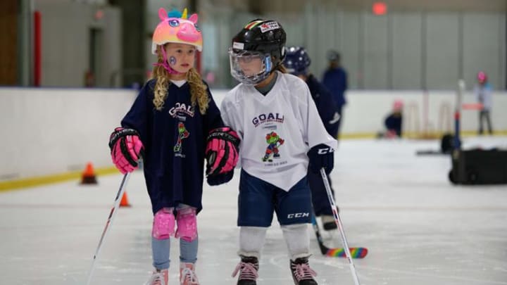 Photo of two young skaters on the ice during a Get Out and Learn session.