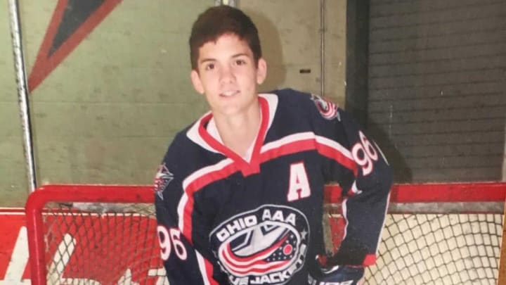 Photo of a young Jack Roslovic in front of the net in Ohio AAA Blue Jackets gear posing for a photo.