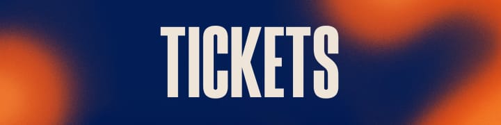 Alt text: A graphic with the word "TICKETS" in large, bold, white letters centered on a background that transitions from deep blue to warm orange. The design is modern and abstract, with softly blended colors creating a visually striking contrast that makes the text stand out clearly.