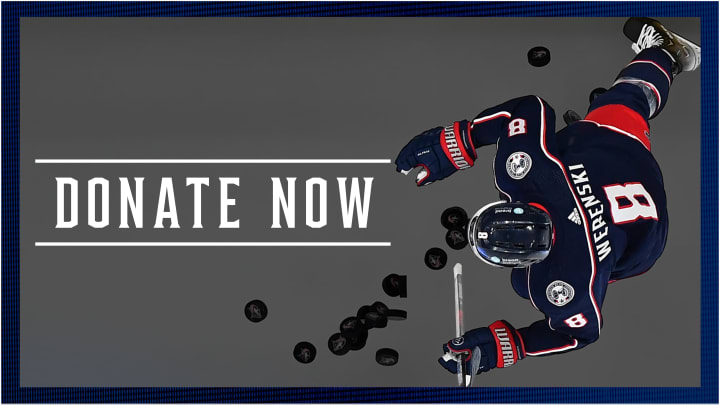 Grey graphic with blue border. Photo of Zach Werenski entering the ice at Nationwide Arena during a home game. White text to the left reads Donate Now.