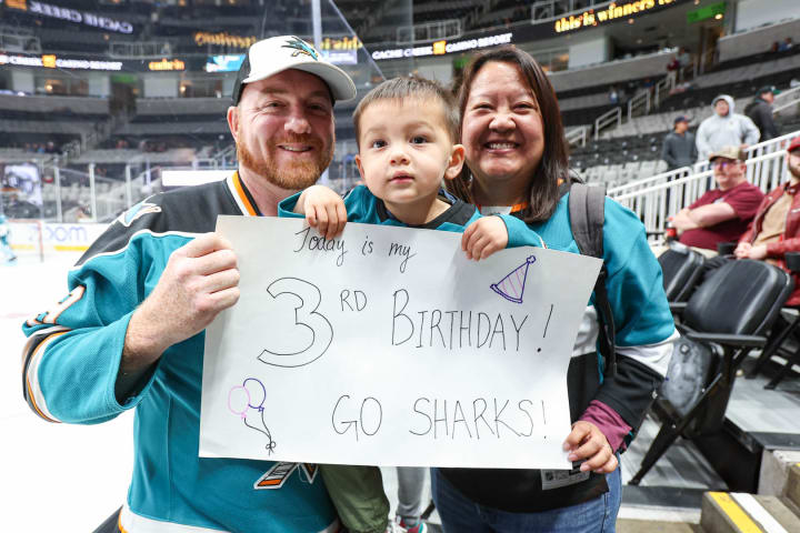 Family celebrates sons third birthday at a Sharks game