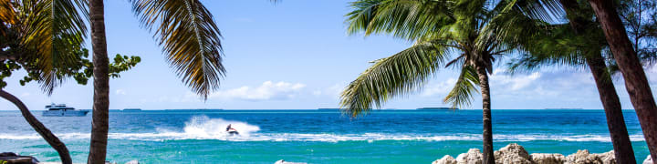 Jet ski and boat on the ocean by the beach