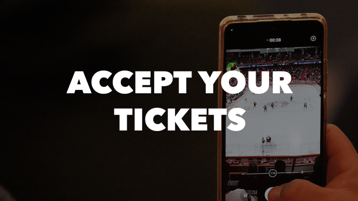 Photo of a phone taking a picture of the ice at an Ottawa Senators game at the Canadian Tire Centre with the words "Accept Your Tickets" in white letters.