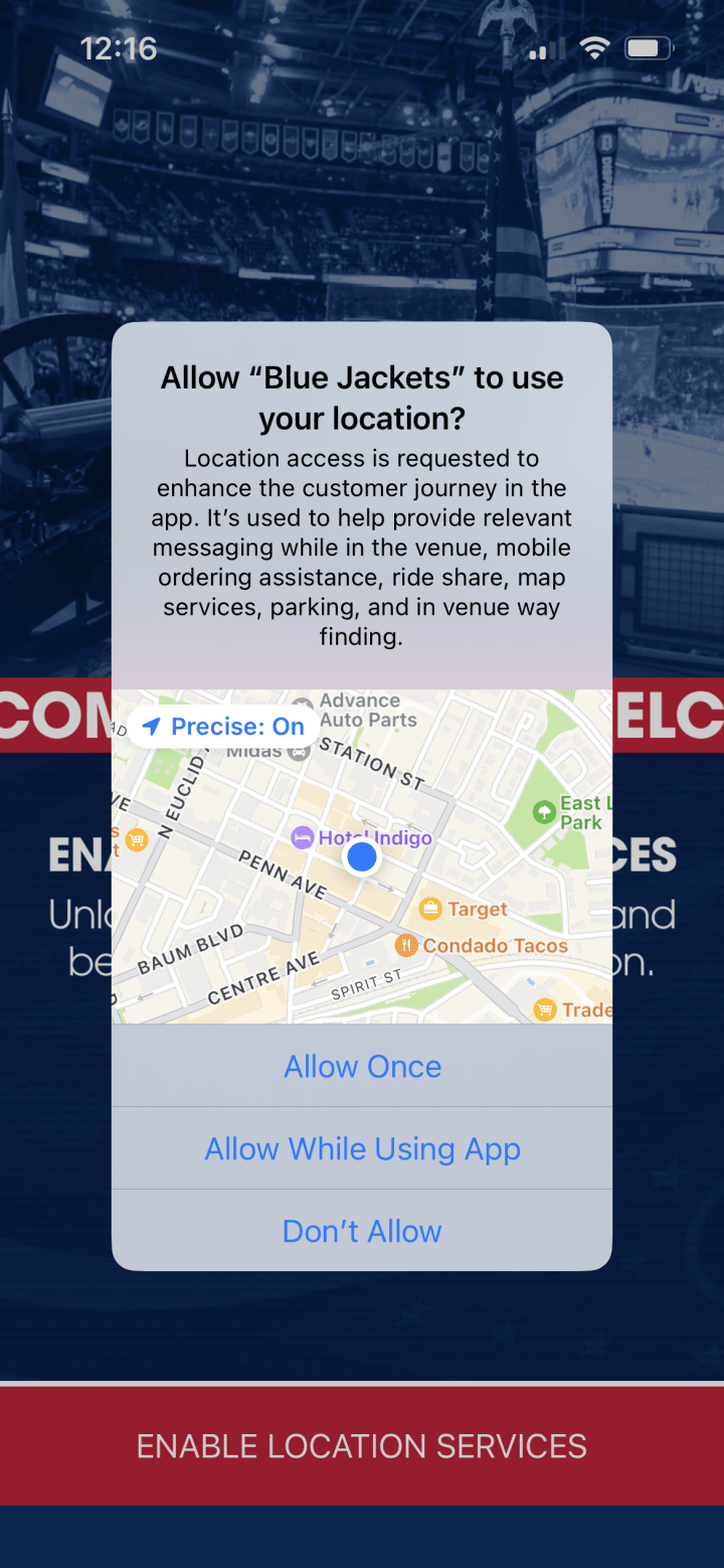 Screenshot of Allow Location Services loading page of Blue Jackets Ap. Apple iPhone overlay with option for the Blue Jackets App to use the users location overlaid on top of the app screen.