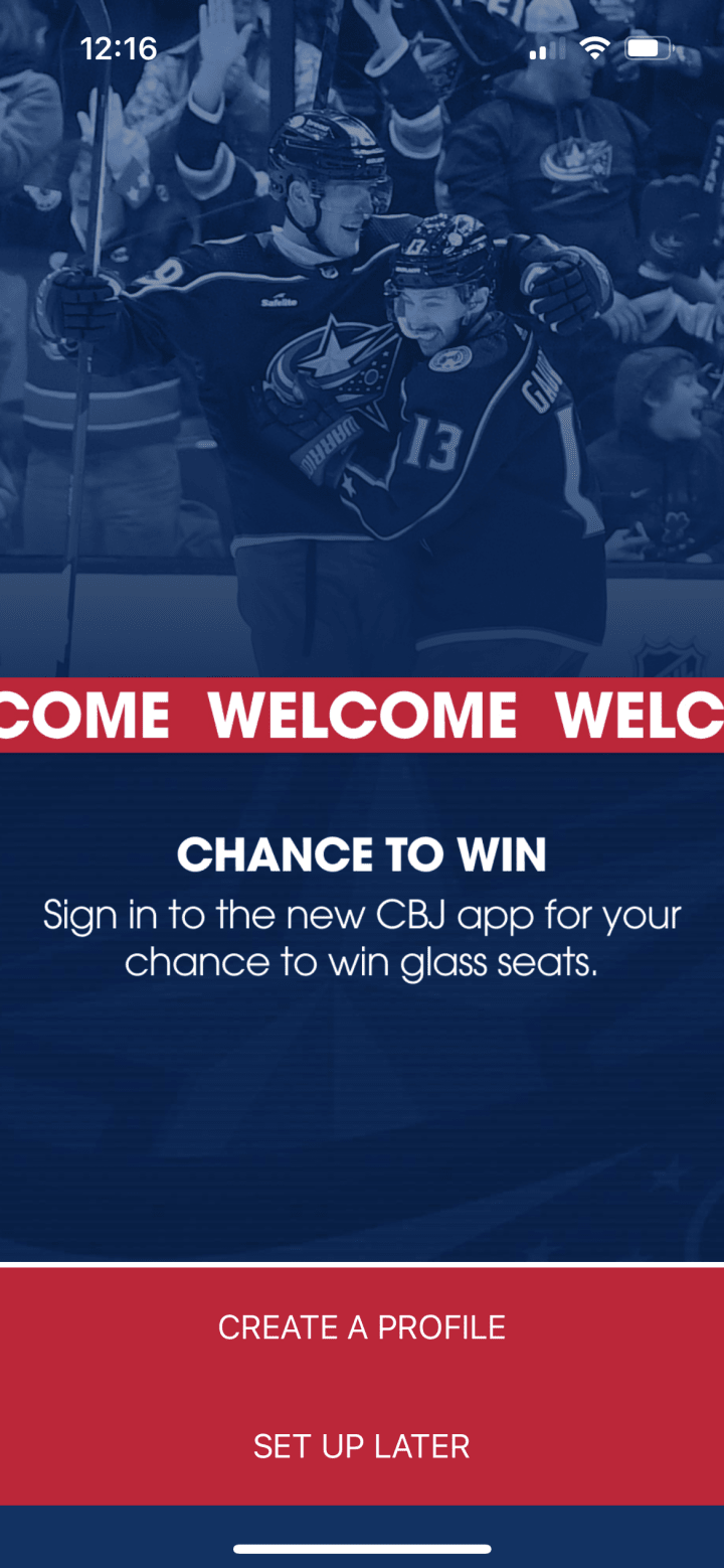 Screenshot of Blue Jackets app Chance to Win loading screen. Blue graphic with white text reading Chance to Win. Smaller white text below reads Sign in to the new CBJ app for your chance to win glass seats. Two red buttons below read Create a Profile and Set Up Later.