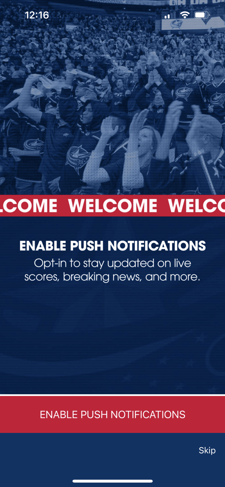 Screenshot of push notification loading screen of Blue Jackets app. Blue graphic with white text reading Enable Push Notifications. Smaller white text below reads Opt-in to stay updated on live scores, breaking news, and more. Red button at the bottom reads Enable Push Notifications. Small white text in the bottom right corner reads Skip.