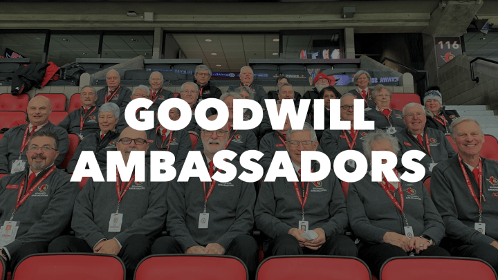 An image of Goodwill Ambassadors staff sitting in the stands of the Canadian Tire Centre with the words "Goodwill Ambassadors" in bold white letters.