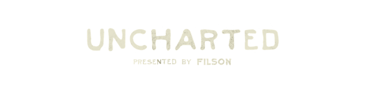 logo that reads uncharted presented by filson
