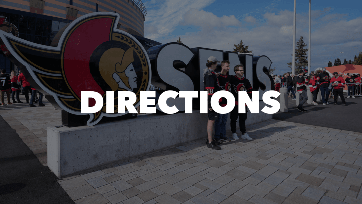 Photo of Ottawa Senators fans posing with the Sens sign outside the Canadian Tire Centre with the words "Directions" in bold white letters.