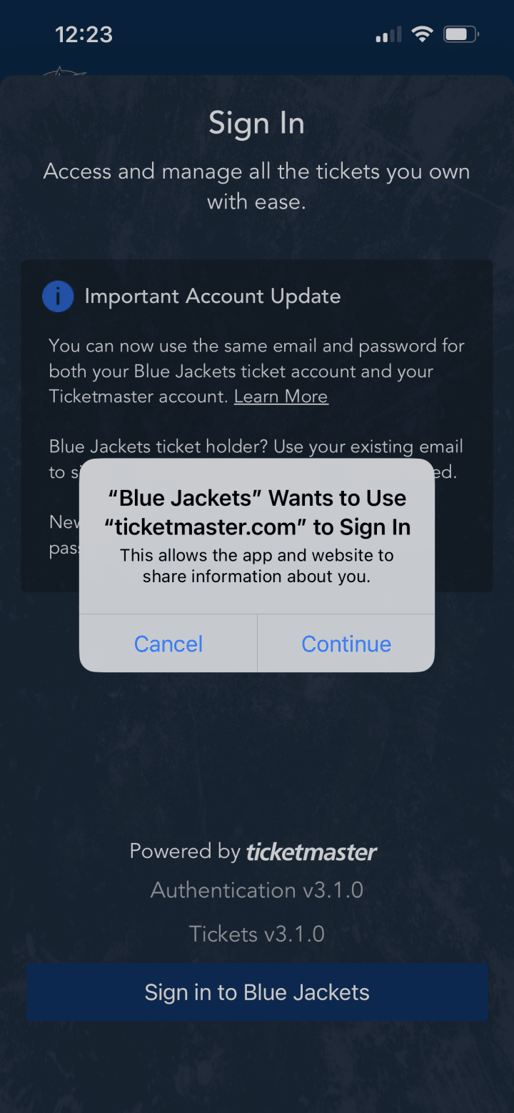 Screenshot of Blue Jackets App Ticketmaster sign in overlay. Apple iPhone white overlay reading "Blue Jackets" Wants to Use "ticketmaster.com" to Sign In. This allows the app and website to share information about you. Blue buttons below read Cancel and Continue.